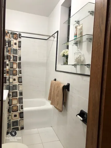 a bathroom with a bathtub and shower