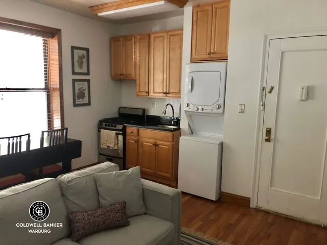 a kitchen with a refrigerator and a stove top oven