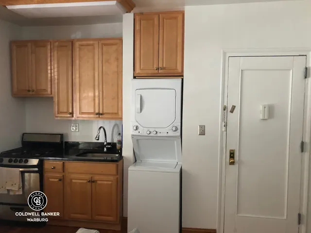 a kitchen with a refrigerator and cabinets