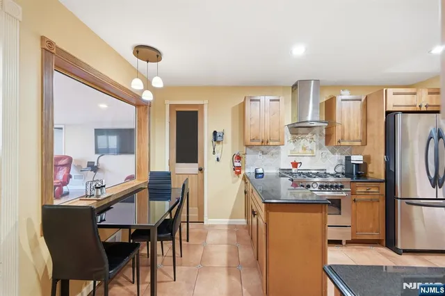 a living room with furniture a flat screen tv and a large window