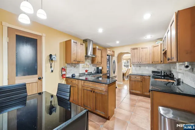 a living room with furniture a flat screen tv and a large window