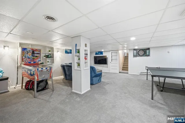 a bedroom with furniture and a air conditioner vent