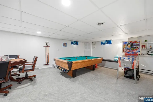 a living room with furniture a table and chairs