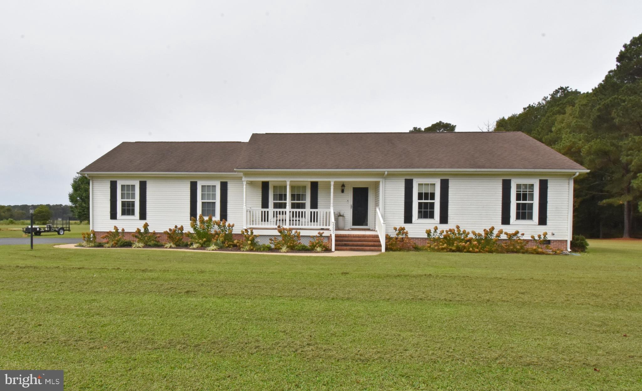 6600 Old Westover Marion Road Westover, MD 21871 - Photo 1 of 52 a front view of a house with a garden and trees