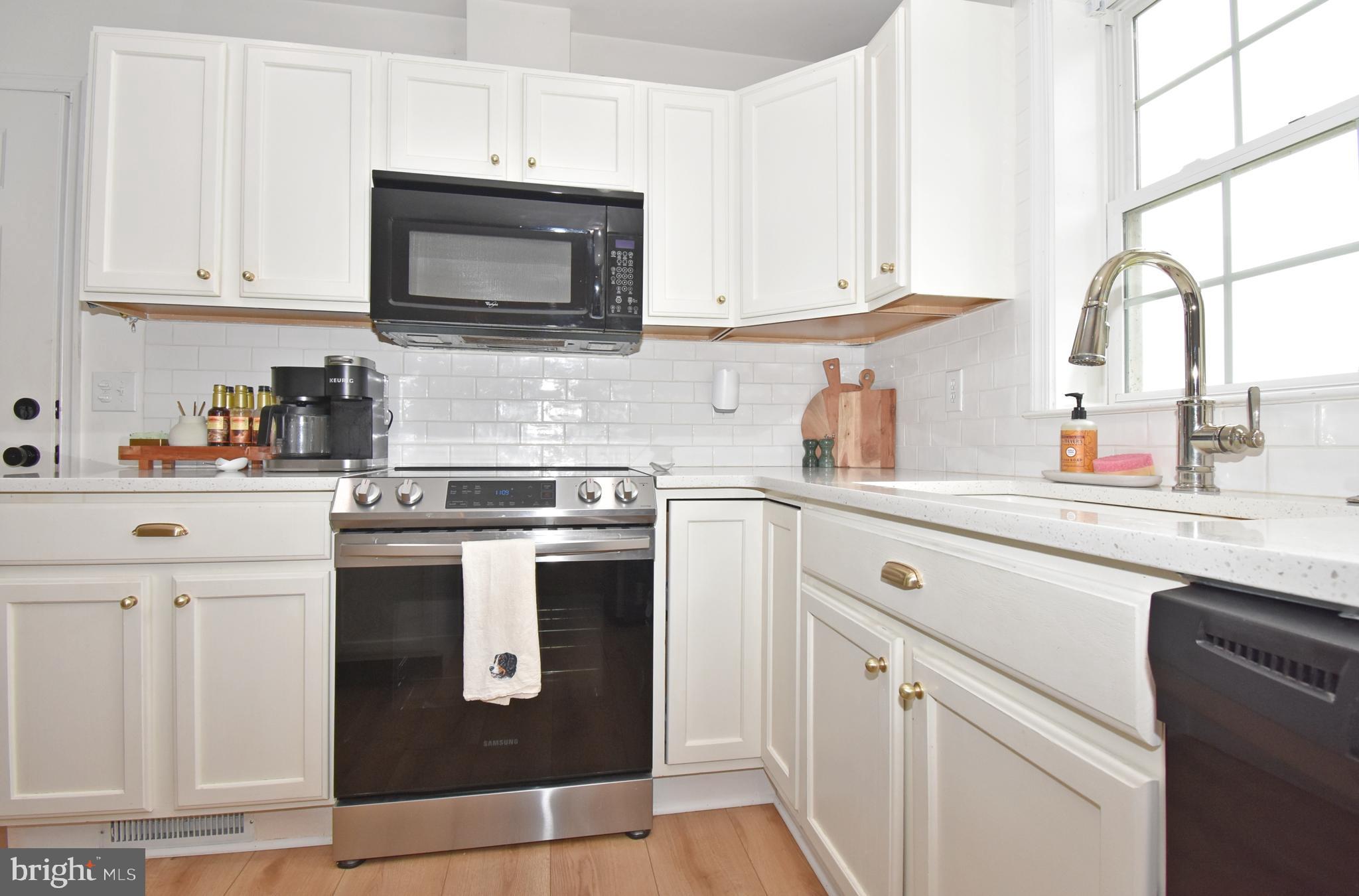 6600 Old Westover Marion Road Westover, MD 21871 - Photo 11 of 52 a kitchen with stainless steel appliances granite countertop a sink and a microwave