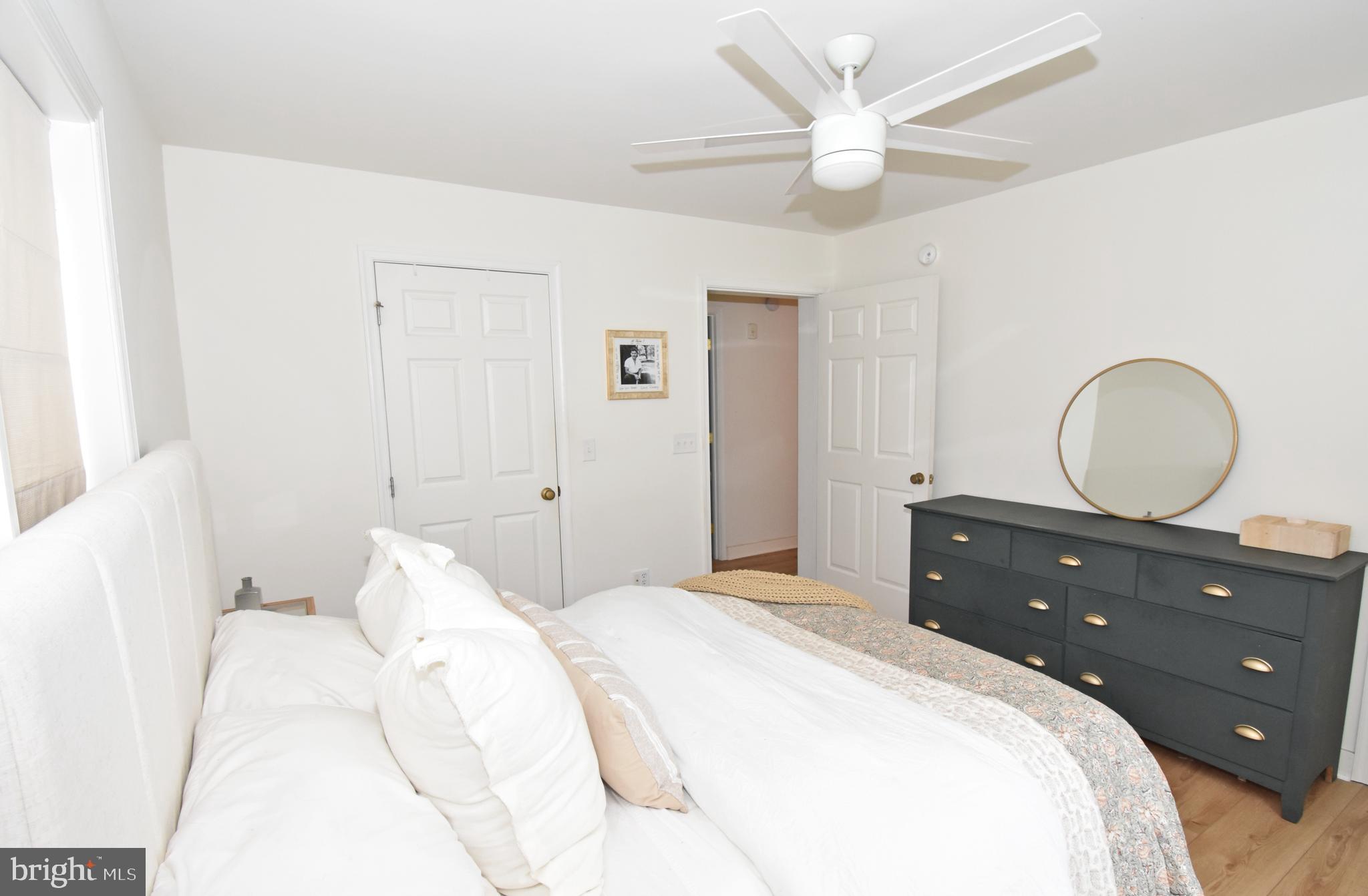 6600 Old Westover Marion Road Westover, MD 21871 - Photo 24 of 52 a bedroom with a bed and a chandelier