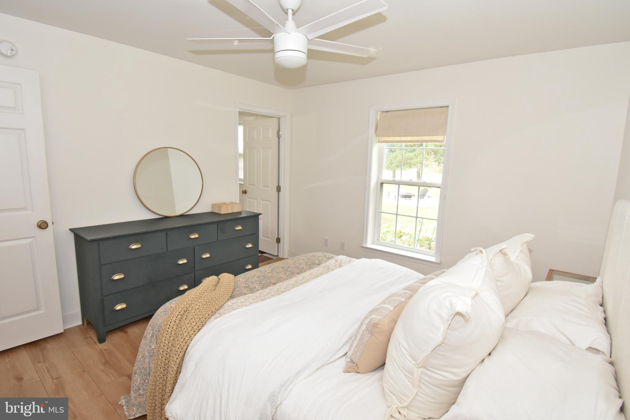 6600 Old Westover Marion Road Westover, MD 21871 - Photo 25 of 52 a bedroom with a bed and a chandelier
