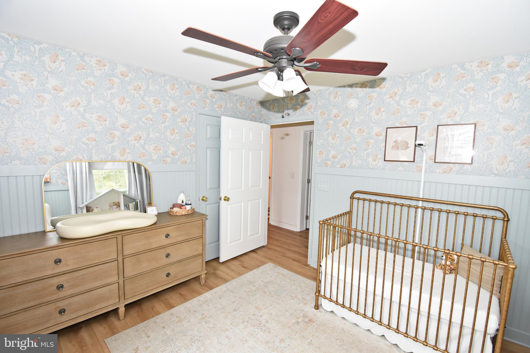 6600 Old Westover Marion Road Westover, MD 21871 - Photo 29 of 52 a bedroom with a bed and a chandelier