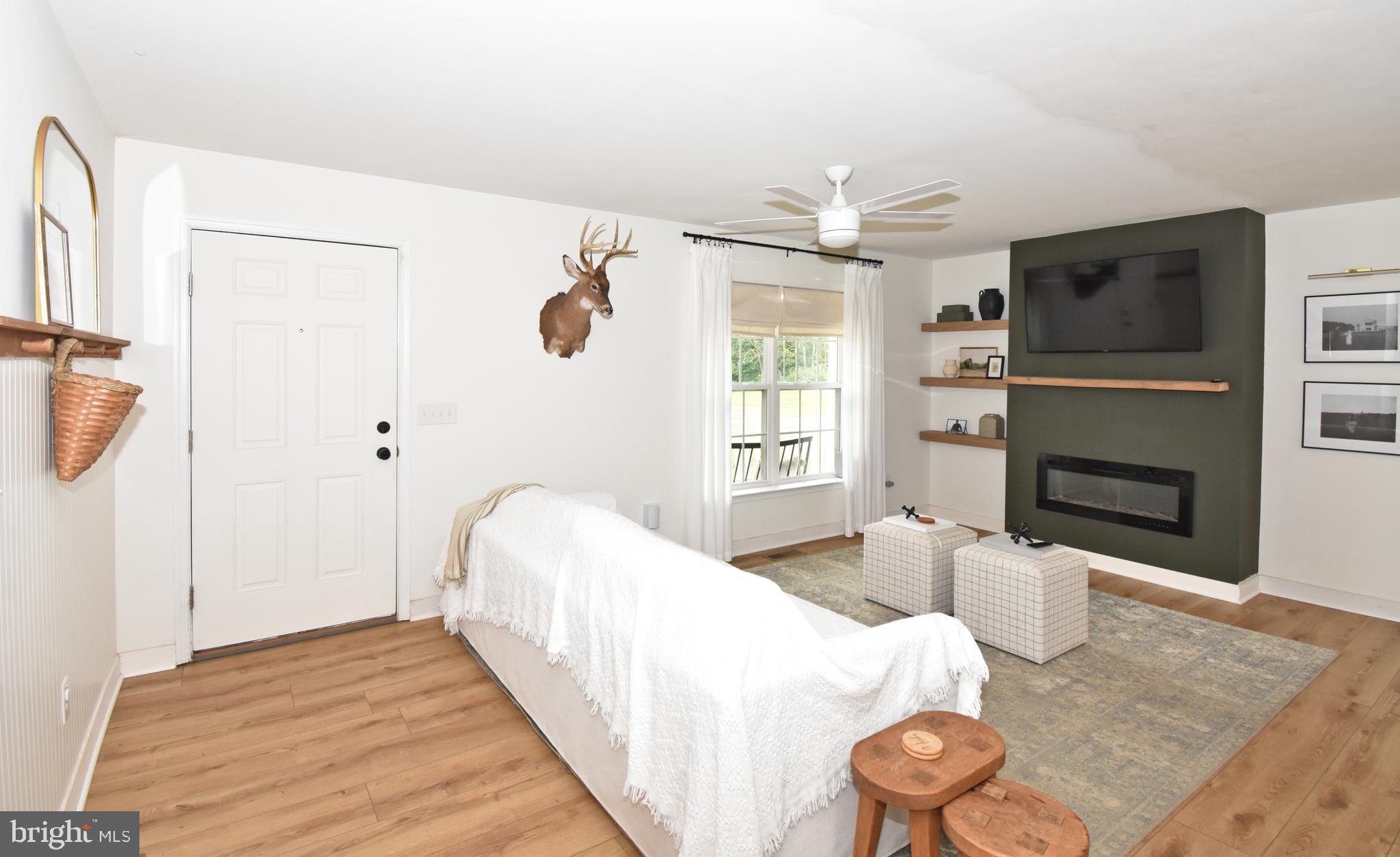 6600 Old Westover Marion Road Westover, MD 21871 - Photo 3 of 52 a bedroom with a bed and a chandelier
