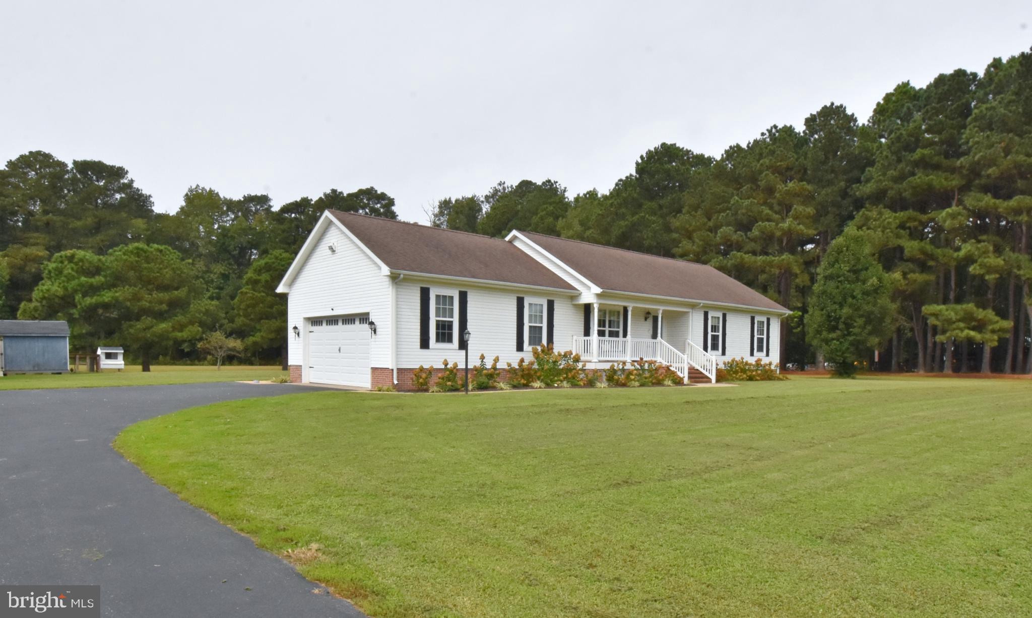 6600 Old Westover Marion Road Westover, MD 21871 - Photo 39 of 52 a front view of a house with a garden and trees