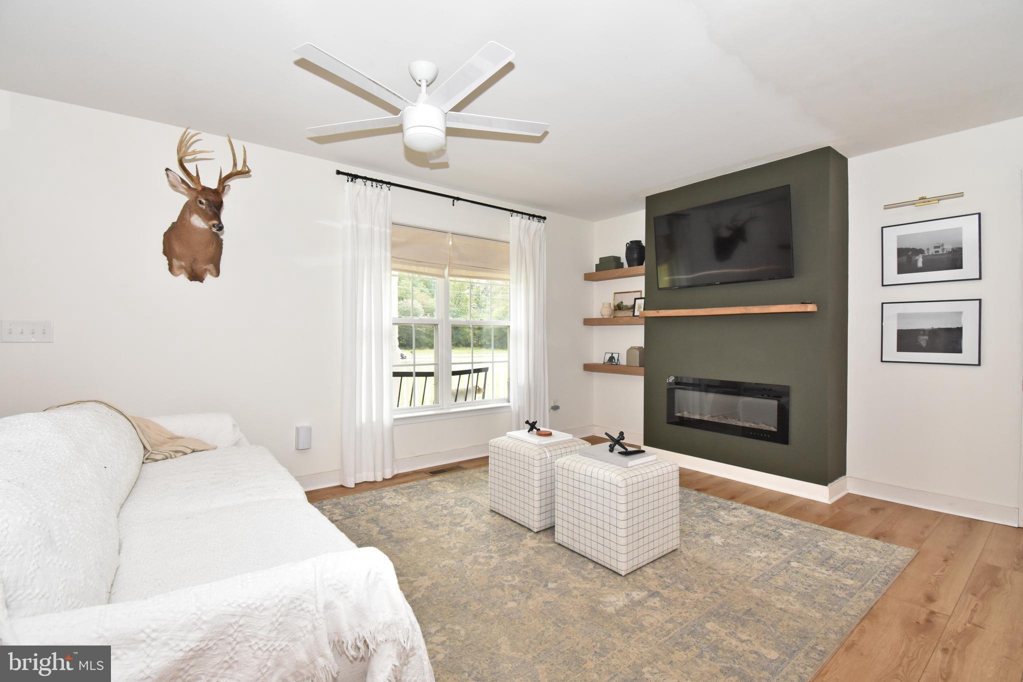 6600 Old Westover Marion Road Westover, MD 21871 - Photo 4 of 52 a spacious bedroom with a bed and a fireplace