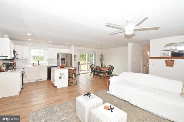 a living room with furniture and kitchen view