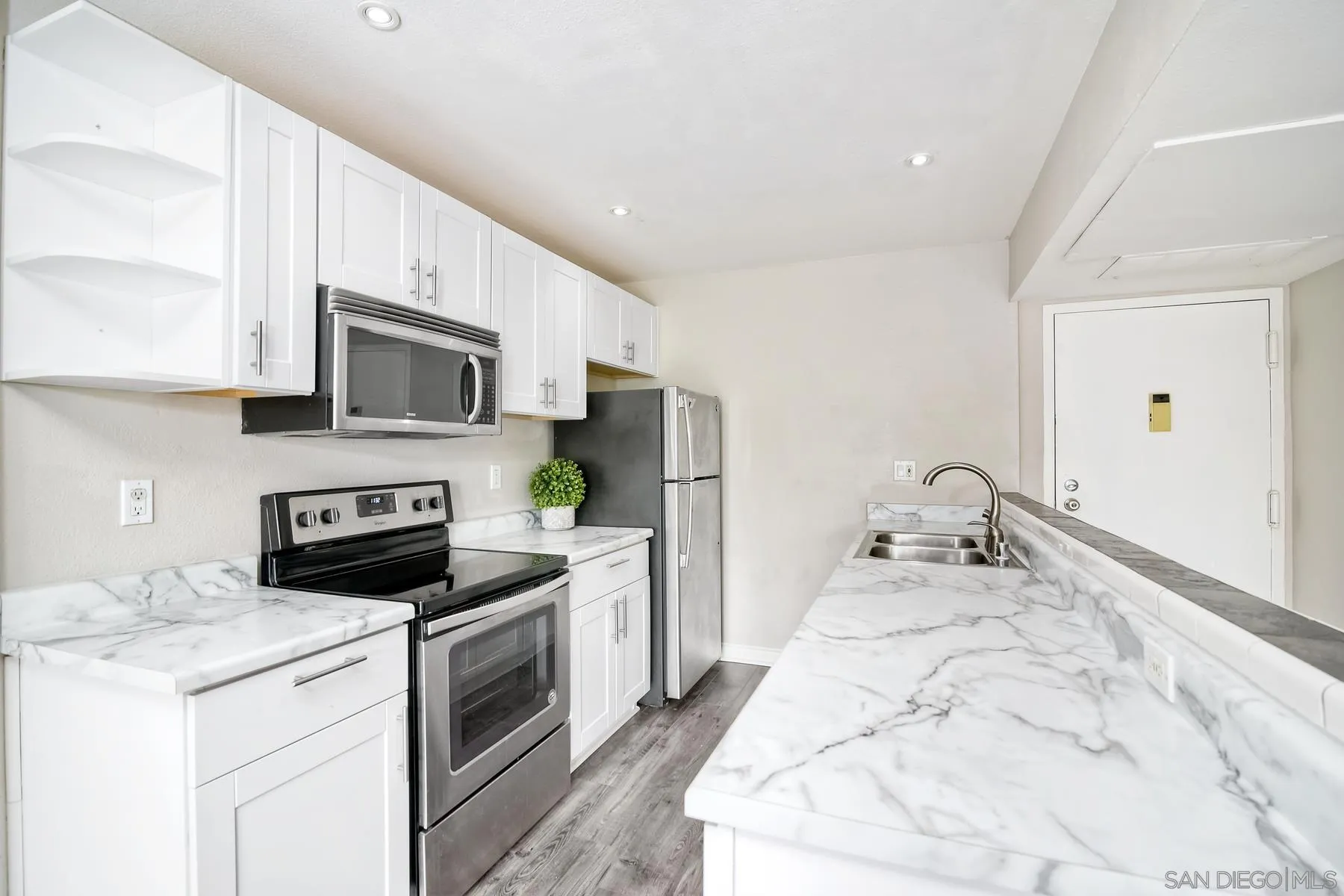 6151 Rancho Mission Road, Unit 317 San Diego, CA 92108 - Photo 1 of 31 a kitchen with a sink stove and refrigerator
