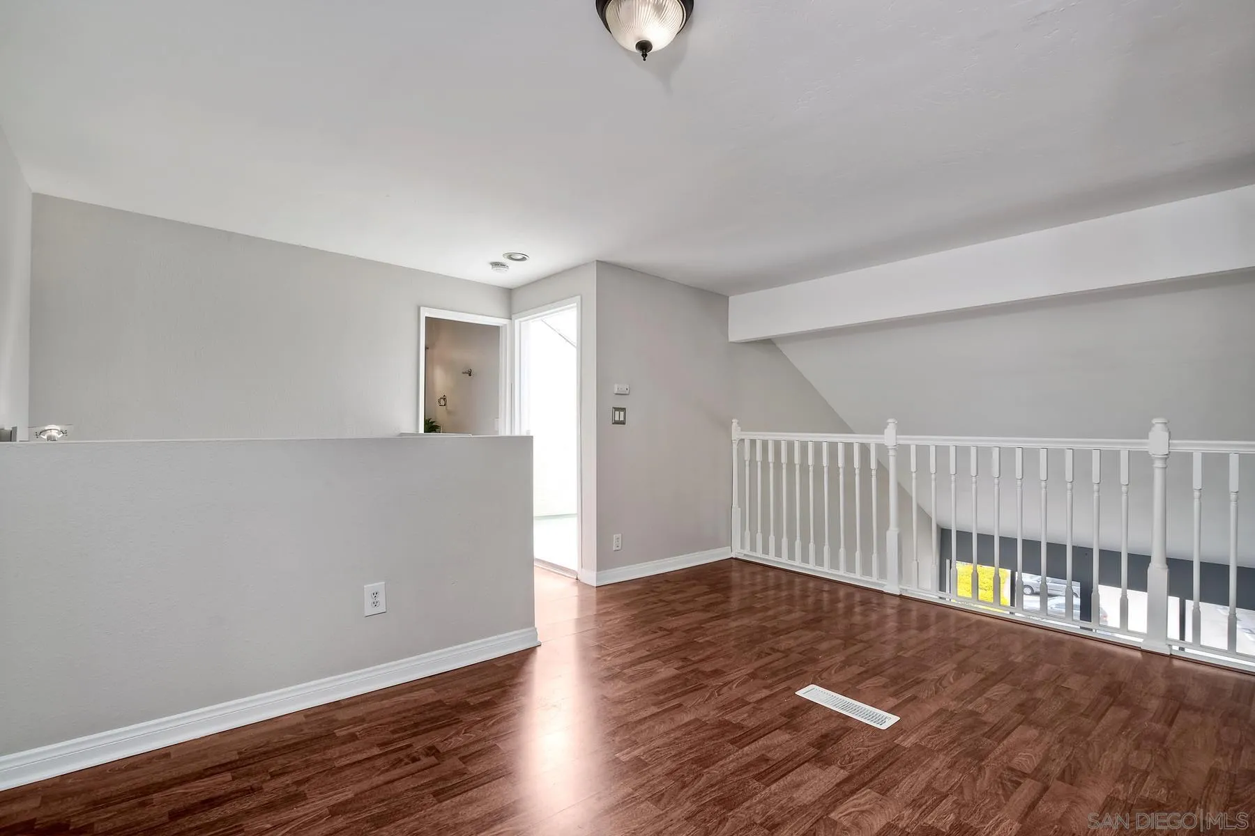 6151 Rancho Mission Road, Unit 317 San Diego, CA 92108 - Photo 15 of 31 a view of an empty room with wooden floor