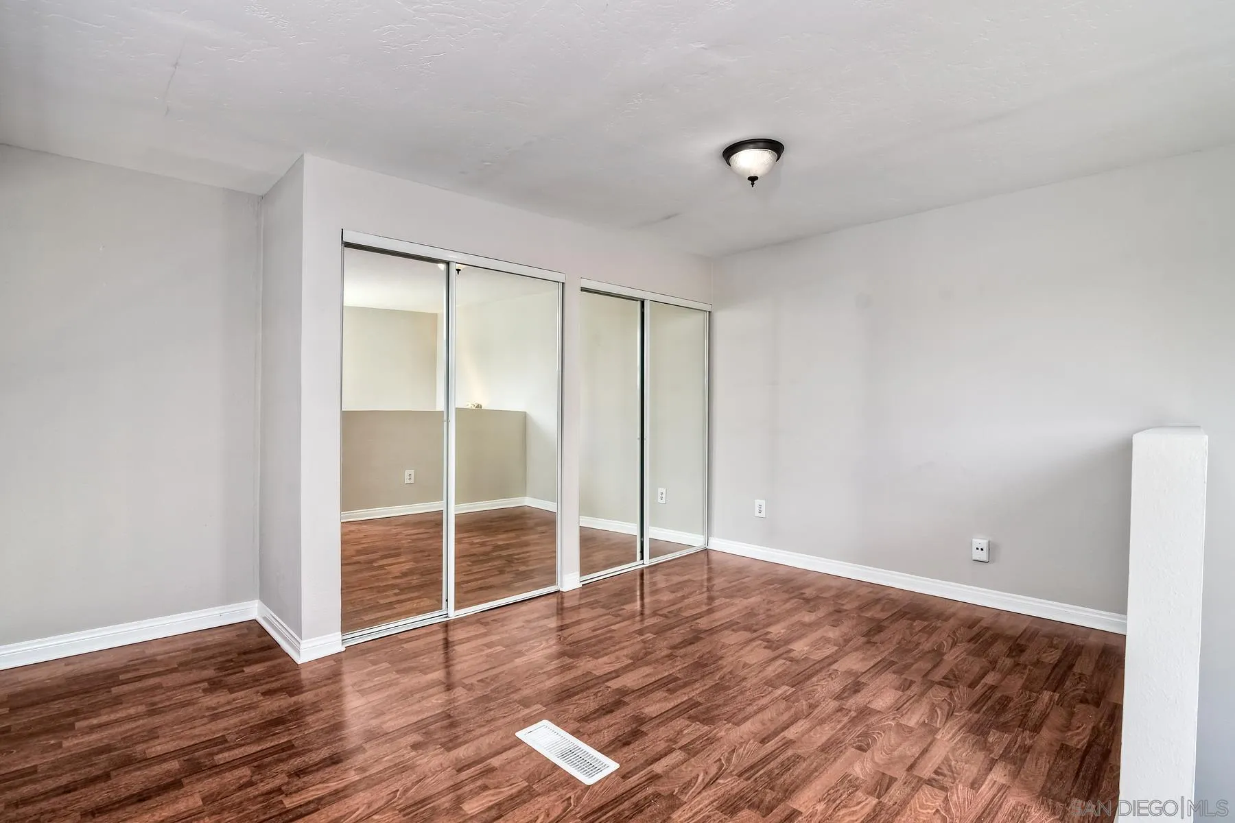 6151 Rancho Mission Road, Unit 317 San Diego, CA 92108 - Photo 18 of 31 an empty room with wooden floor and windows