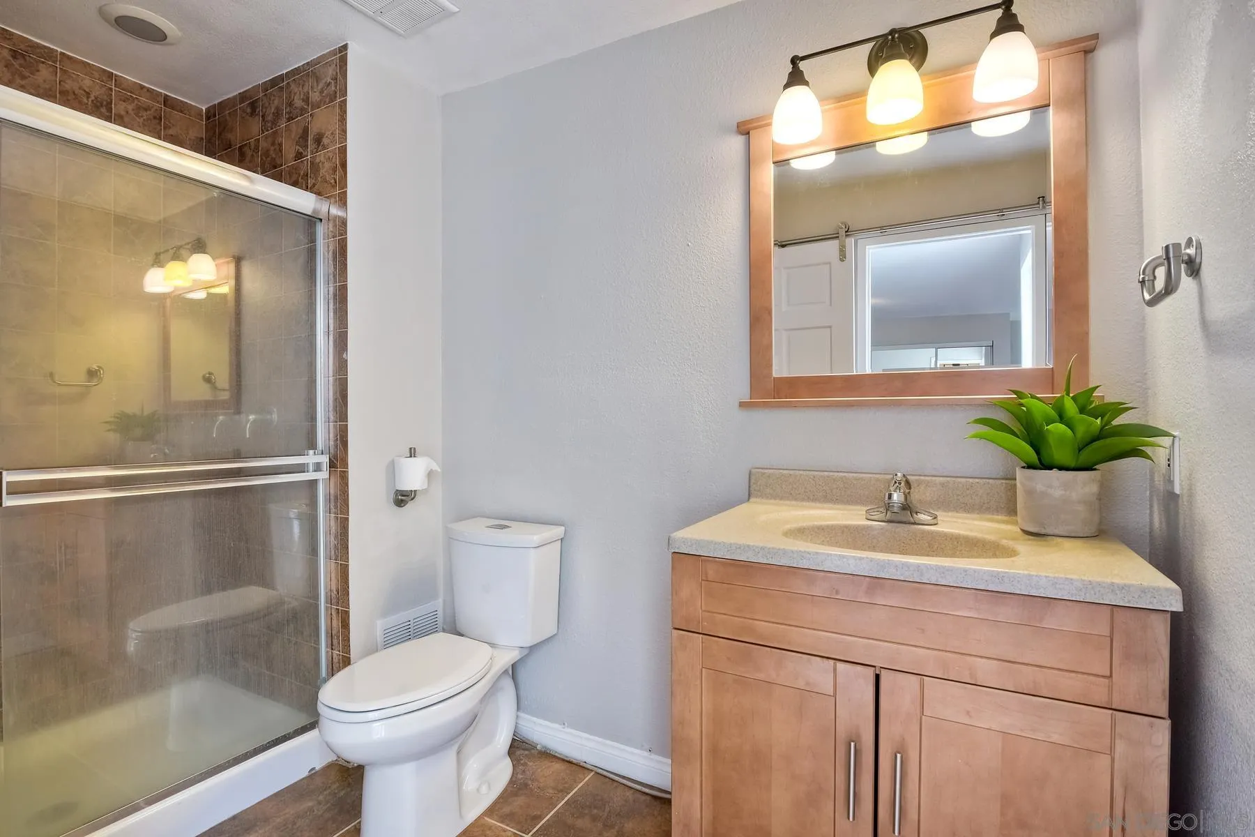 6151 Rancho Mission Road, Unit 317 San Diego, CA 92108 - Photo 19 of 31 a bathroom with a sink toilet and shower