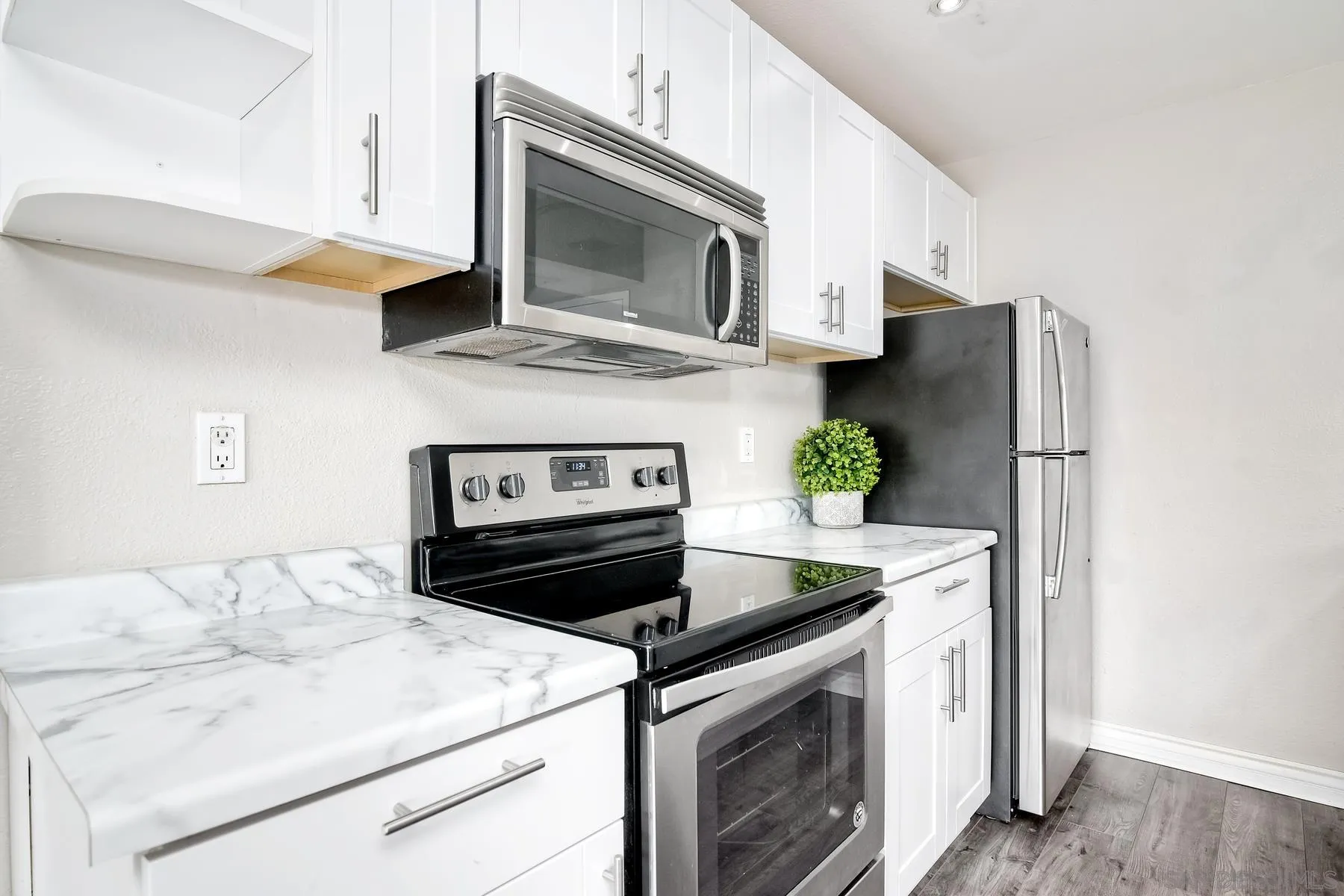 6151 Rancho Mission Road, Unit 317 San Diego, CA 92108 - Photo 2 of 31 a kitchen with stainless steel appliances granite countertop a stove microwave and refrigerator