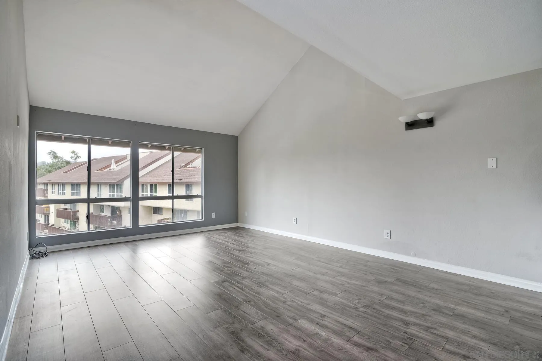 6151 Rancho Mission Road, Unit 317 San Diego, CA 92108 - Photo 7 of 31 wooden floor in an empty room with a window