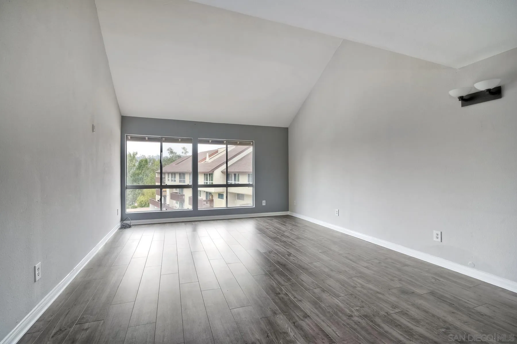 6151 Rancho Mission Road, Unit 317 San Diego, CA 92108 - Photo 9 of 31 an empty room with wooden floor and windows