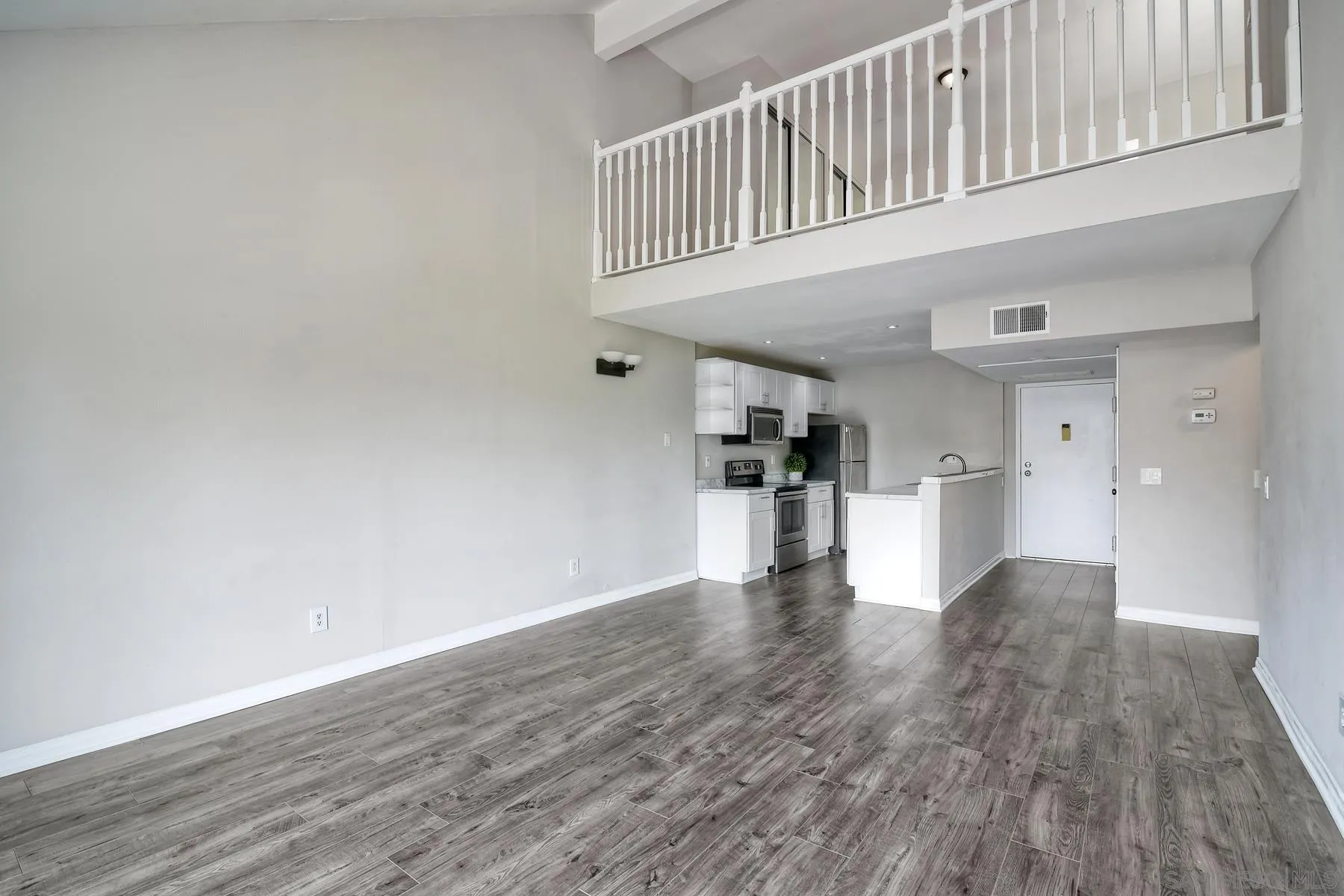 6151 Rancho Mission Road, Unit 317 San Diego, CA 92108 - Photo 10 of 31 a view of empty room with wooden floor