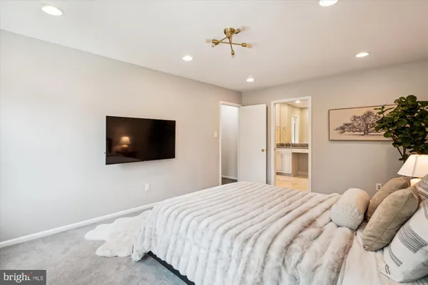 a bedroom with a large bed and a flat screen tv