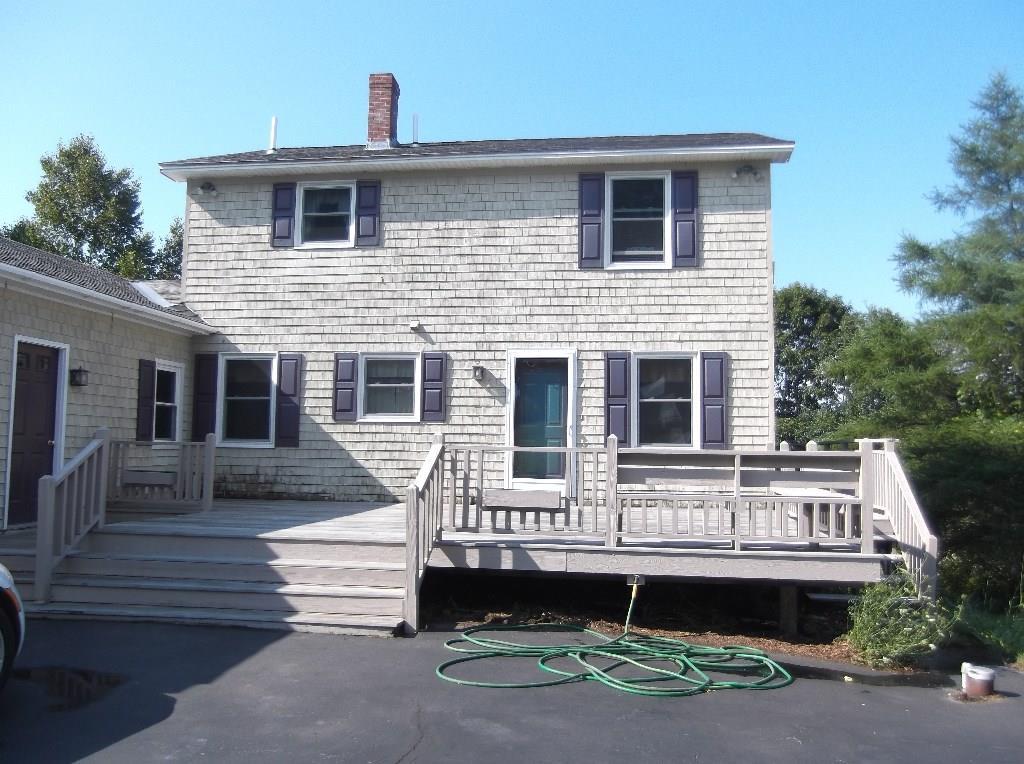 Back of house. Paved driveway and...