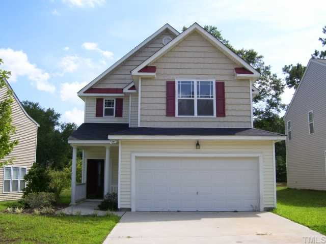 3544 Sunbright Lane Raleigh, NC 27610 - Photo 1 of 9 a front view of a house with garden