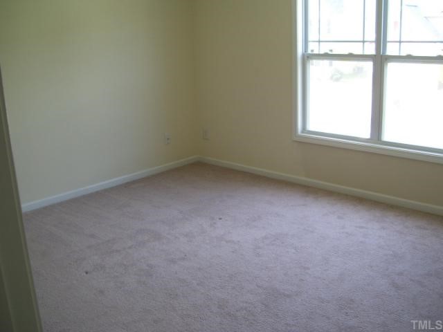 3544 Sunbright Lane Raleigh, NC 27610 - Photo 7 of 9 an empty room with a window