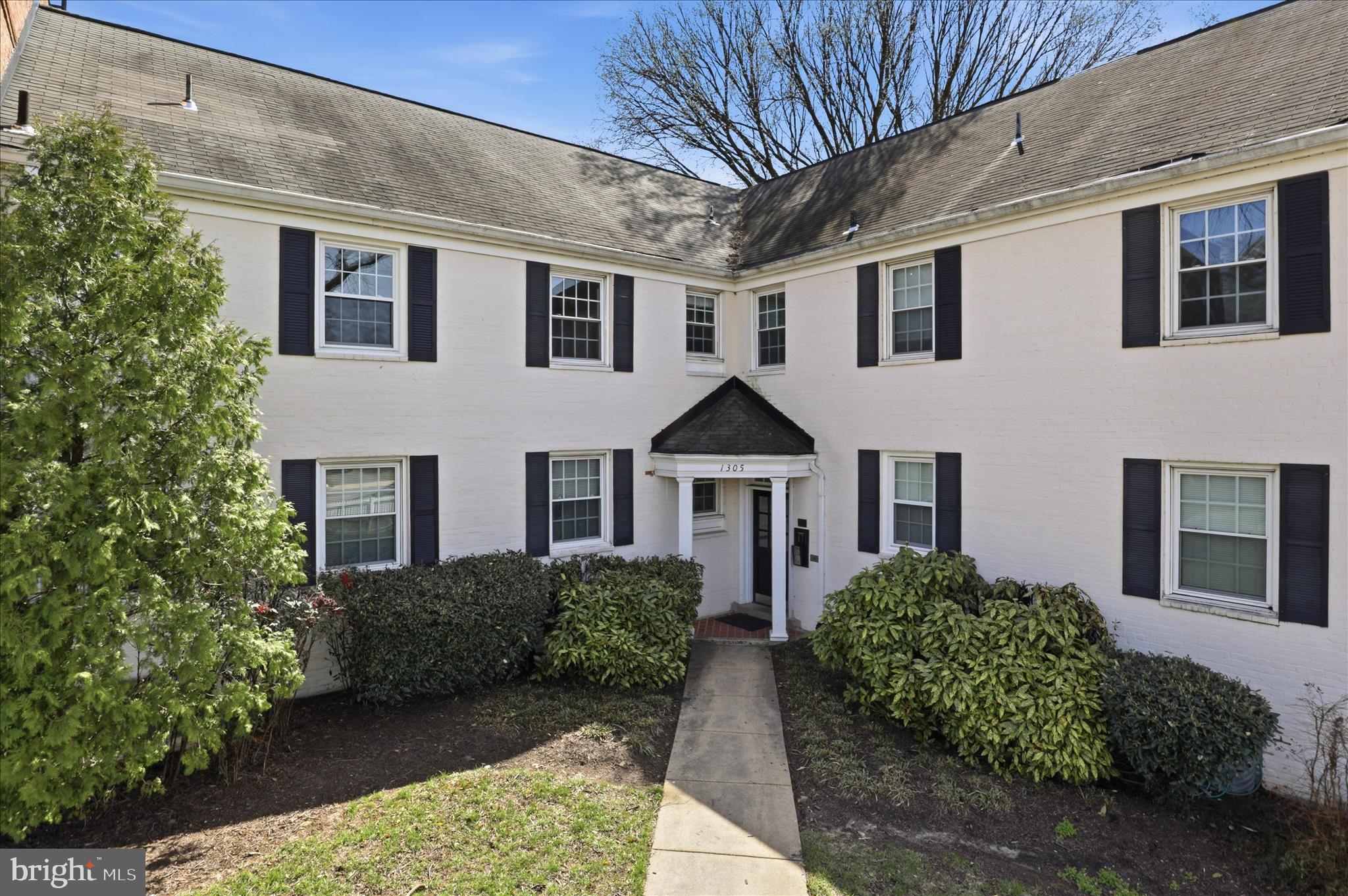 1305 South Walter Reed Drive, Unit 201 Arlington, VA 22204 - Photo 2 of 17 Charming courtyard entrance with greenery