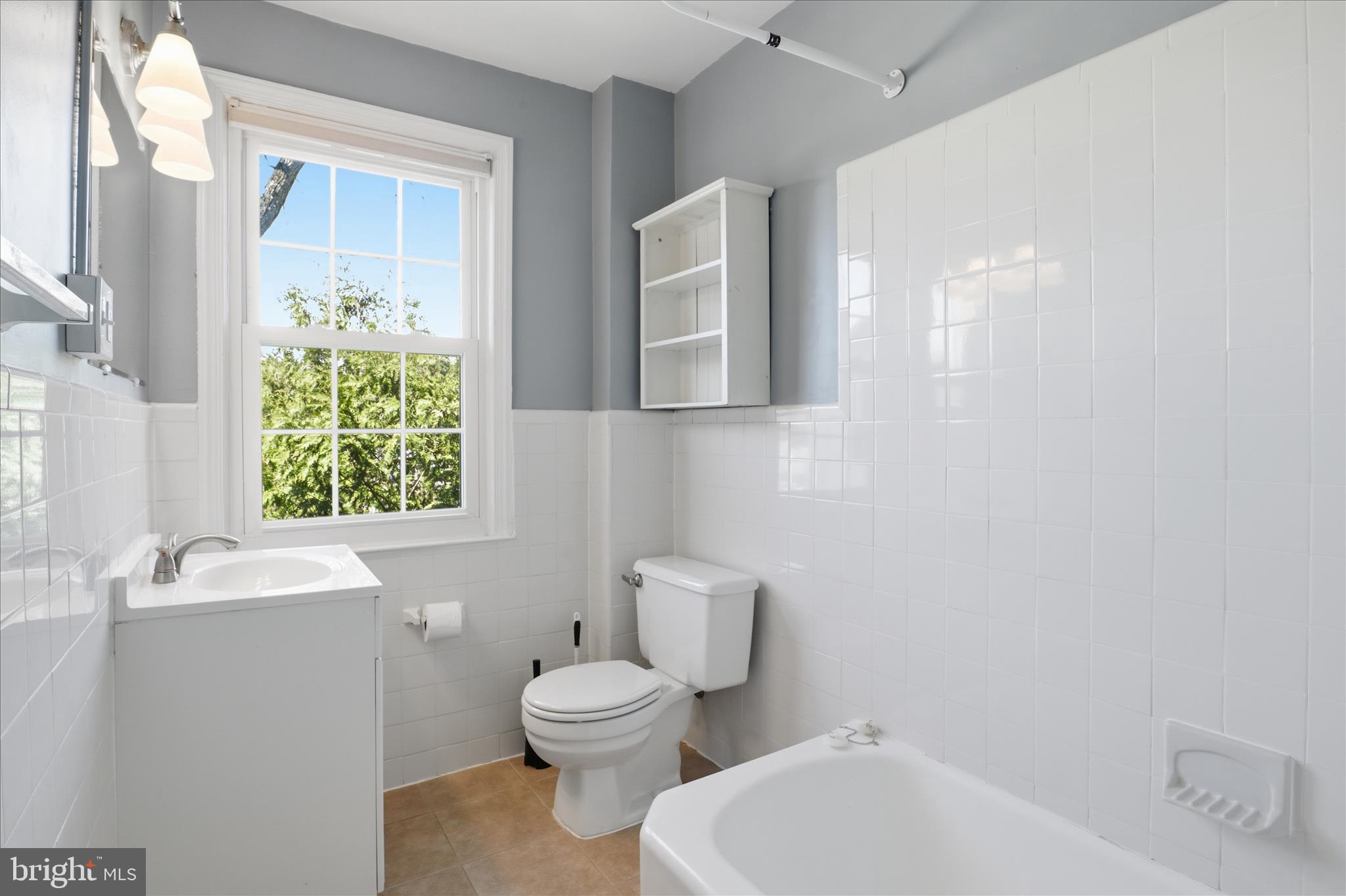 1305 South Walter Reed Drive, Unit 201 Arlington, VA 22204 - Photo 9 of 17 Full bath with timeless tile and natural light