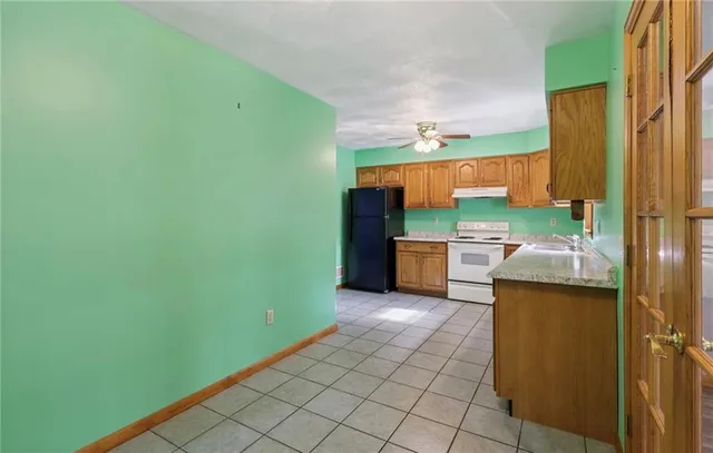 a kitchen with stainless steel appliances wooden cabinets and a refrigerator