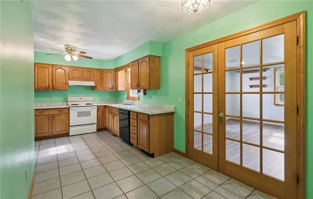 a kitchen with stainless steel appliances granite countertop a stove a sink and a refrigerator