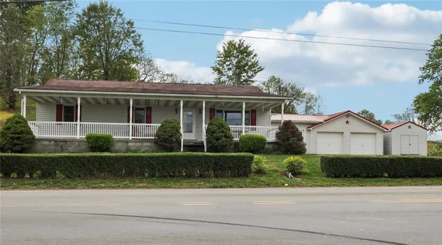 a front view of a house with a garden and plants