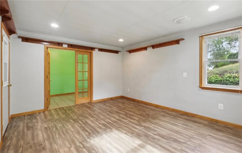 487 East Brady Road Kittanning, PA 16201 - Photo 21 of 50 a view of empty room with wooden floor and fan