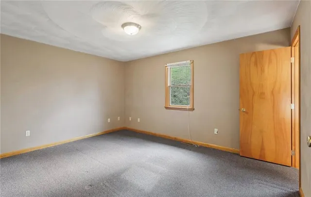 a view of an empty room and a window