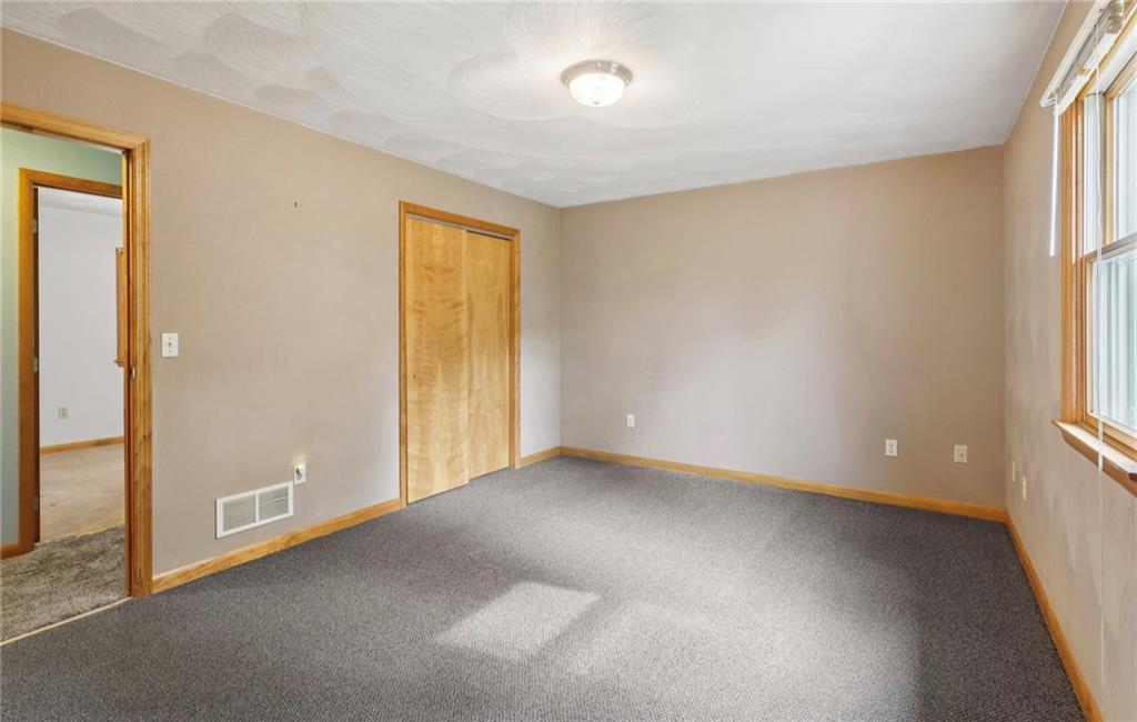 487 East Brady Road Kittanning, PA 16201 - Photo 29 of 50 an empty room with windows and entrance to other room