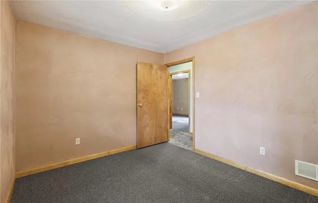 a view of an empty room with stairs