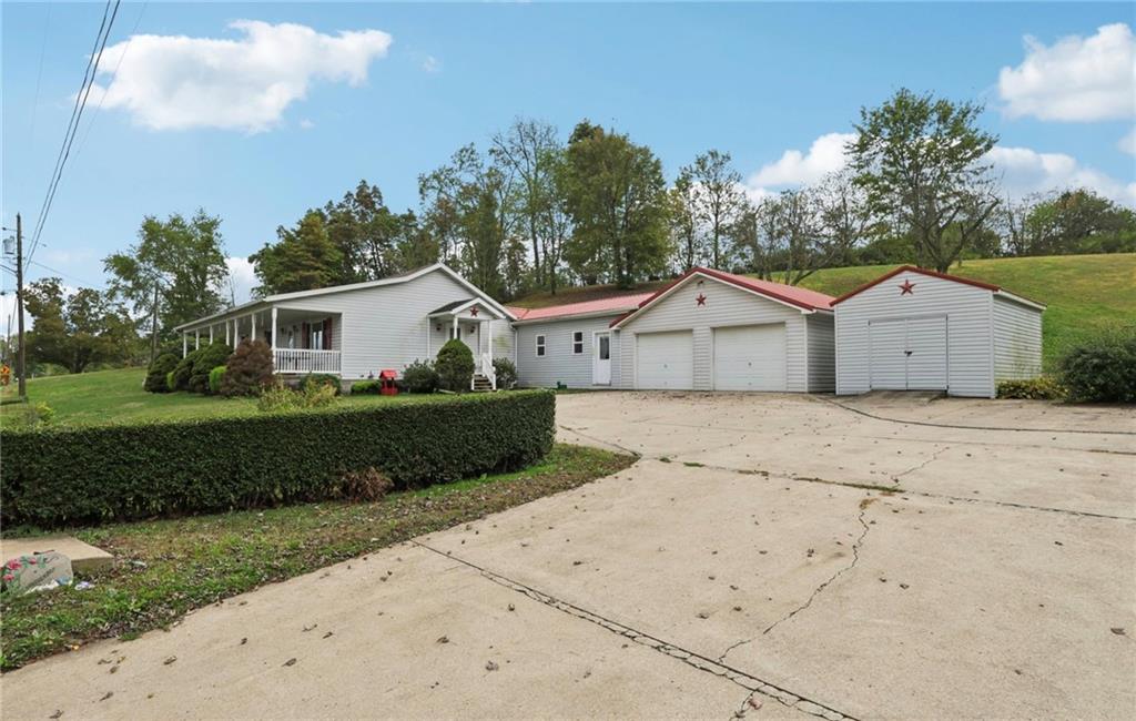 487 East Brady Road Kittanning, PA 16201 - Photo 6 of 50 a front view of a house with a yard and garage