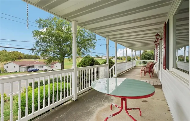 a view of a chairs and table in patio