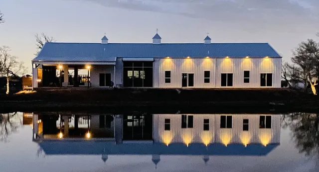 a view of a large building with a big yard and large trees