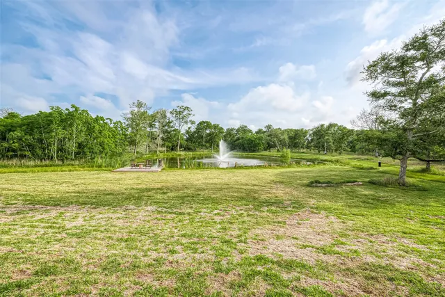 a view of a lake with a table and chairs