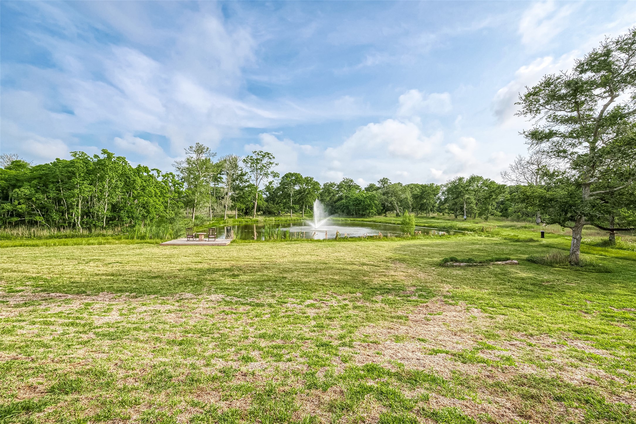 1295 Brazos River Road Freeport, TX 77541 - Photo 25 of 29 a view of a green field with wooden fence