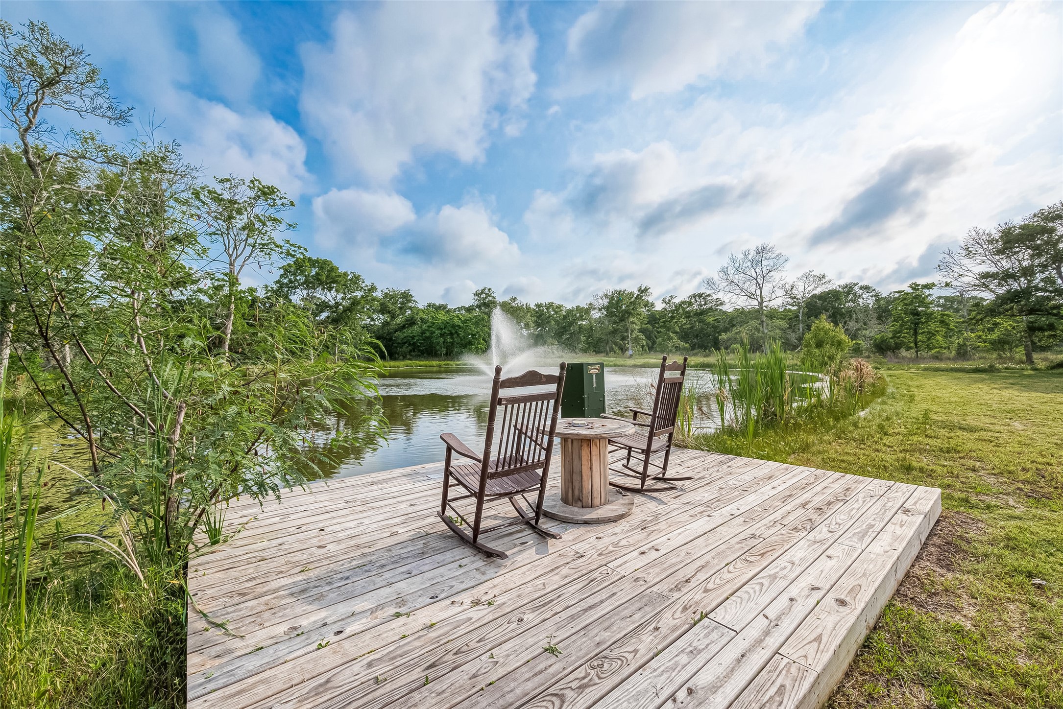 1295 Brazos River Road Freeport, TX 77541 - Photo 27 of 29 a view of a lake with a table and chairs