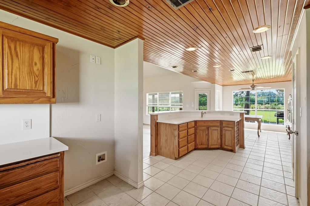 12190 Bell Road Pilot Point, TX 76258 - Photo 17 of 39 Spacious kitchen featuring a wood-plank ceiling with recessed lighting, light wood cabinetry, white countertops, and light tile flooring