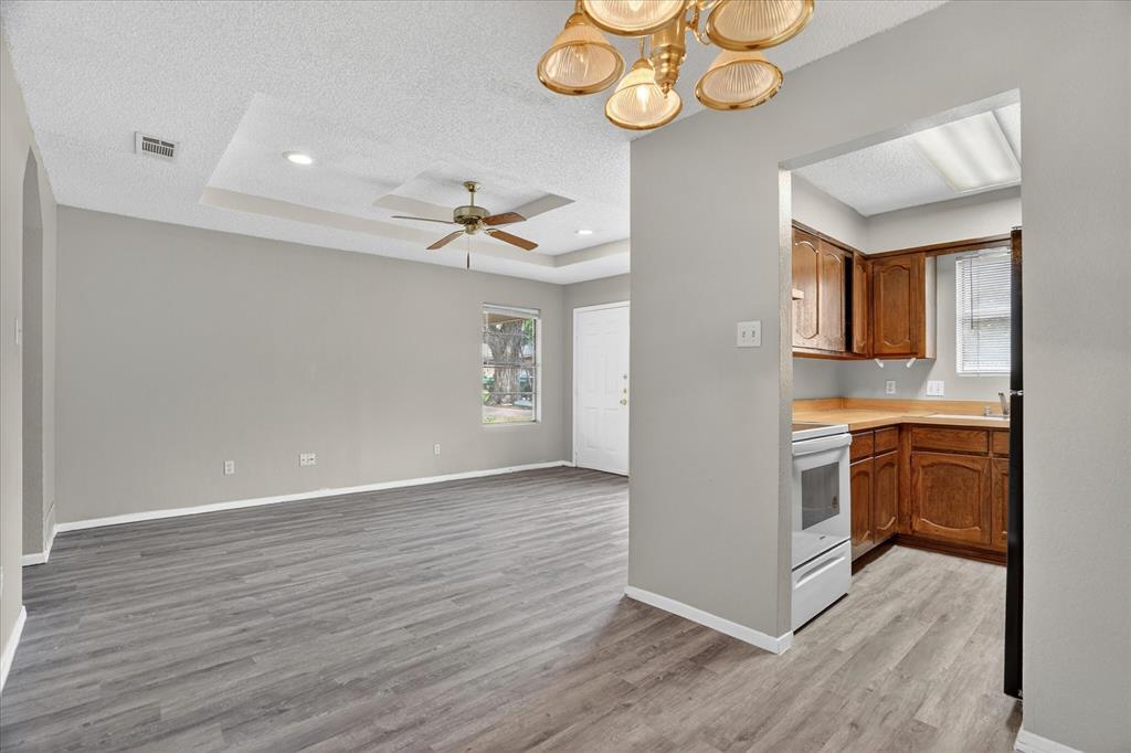 119 Del Rio Avenue, Unit C Benbrook, TX 76126 - Photo 6 of 17 wooden floor in an empty room with a window