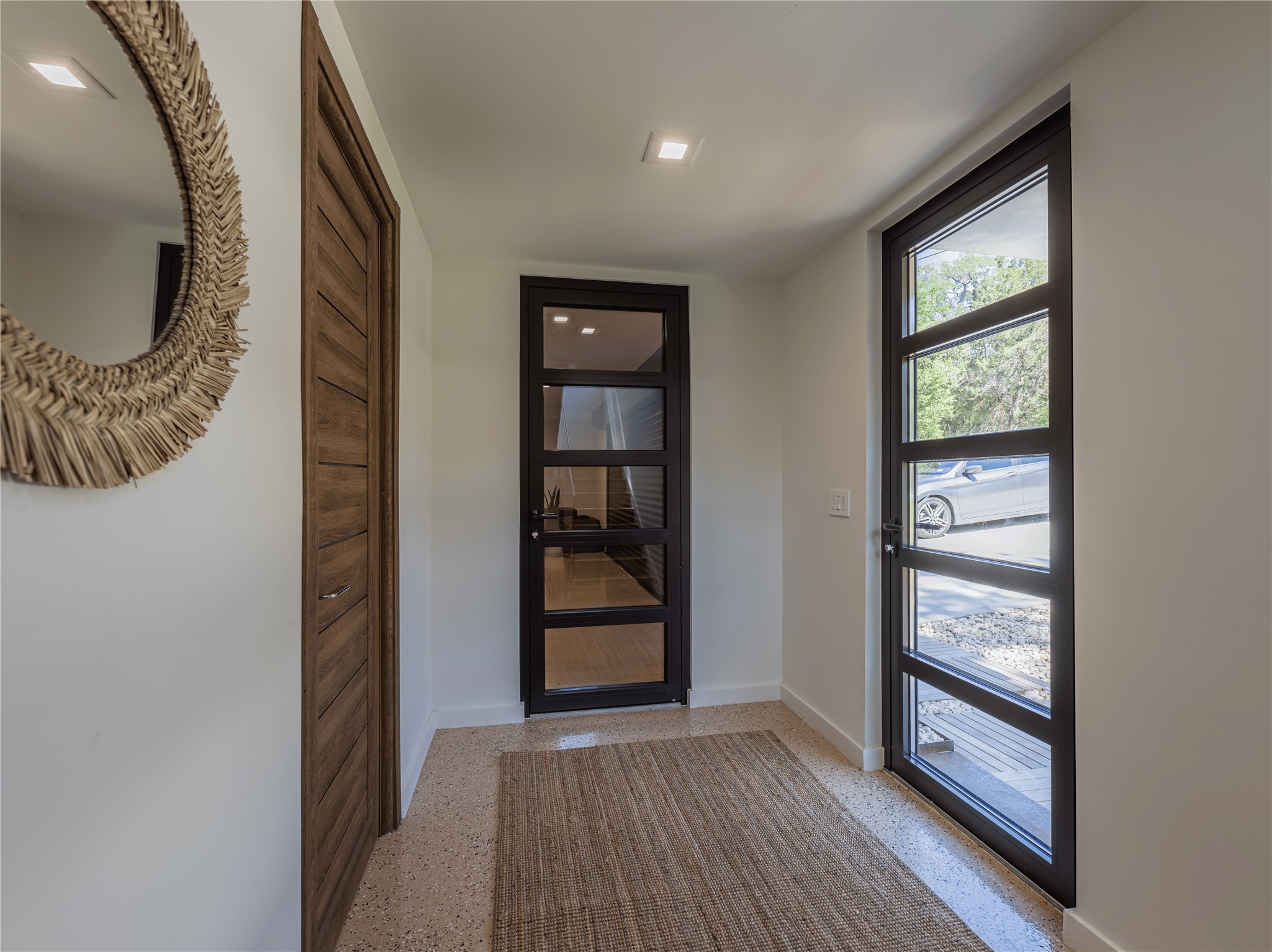 2806 Geronimo Trail Austin, TX 78734 - Photo 24 of 36 an entryway with wooden floor cabinet and door