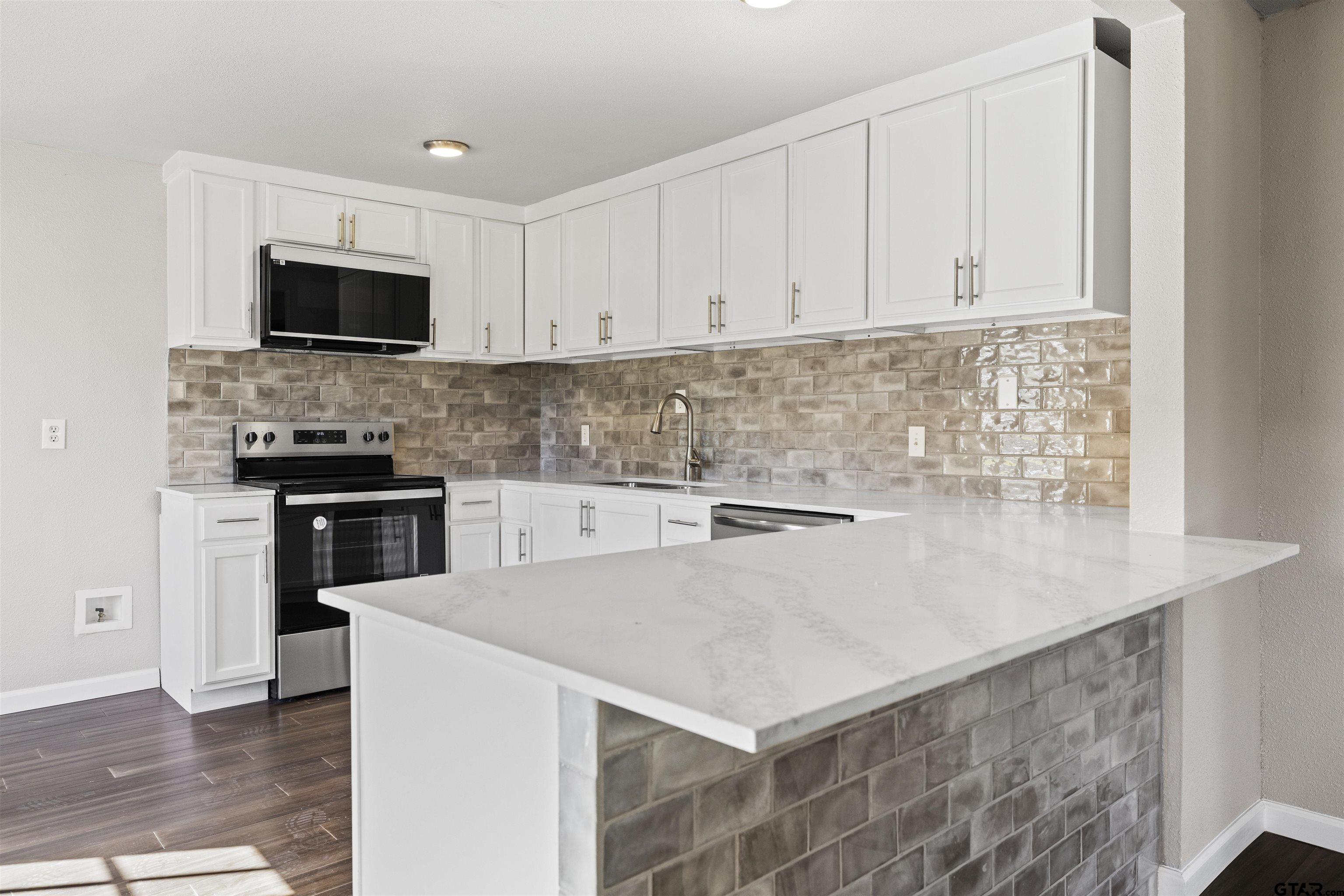 229 Orchard Street Alba, TX 75410 - Photo 8 of 16 a kitchen with stainless steel appliances a stove microwave and sink