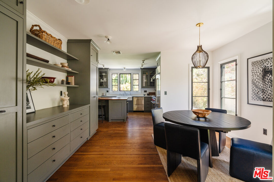 1175 Sonoma Drive Altadena, CA 91001 - Photo 19 of 68 a dining room with wooden floor a chandelier a wooden table and chairs