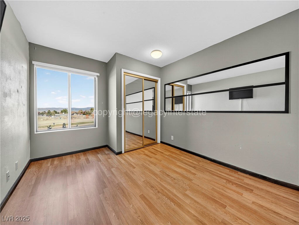 390 East 300 South, Unit 3A Parowan, UT 84761 - Photo 13 of 25 Unfurnished bedroom with light wood-style flooring and a closet