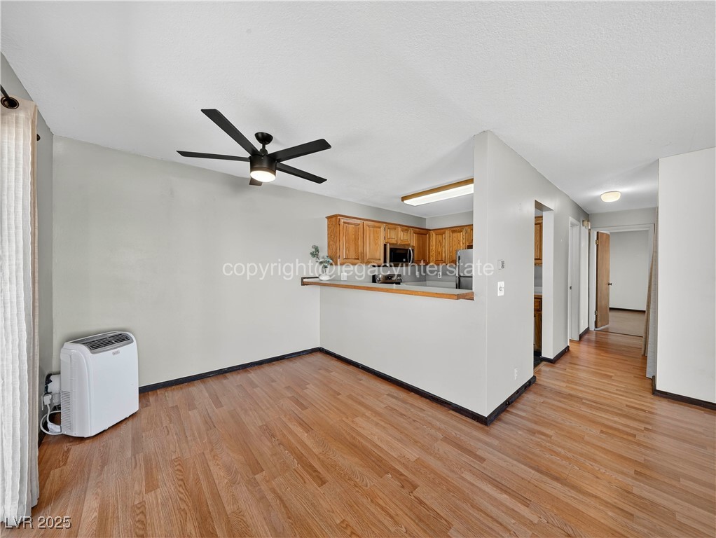390 East 300 South, Unit 3A Parowan, UT 84761 - Photo 7 of 25 Unfurnished living room with light wood-style floors and a ceiling fan